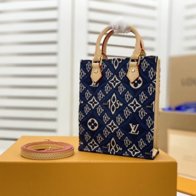 PETIT SAC PLAT BLUE MONOGRAM SINCE 1854 TEXTILE