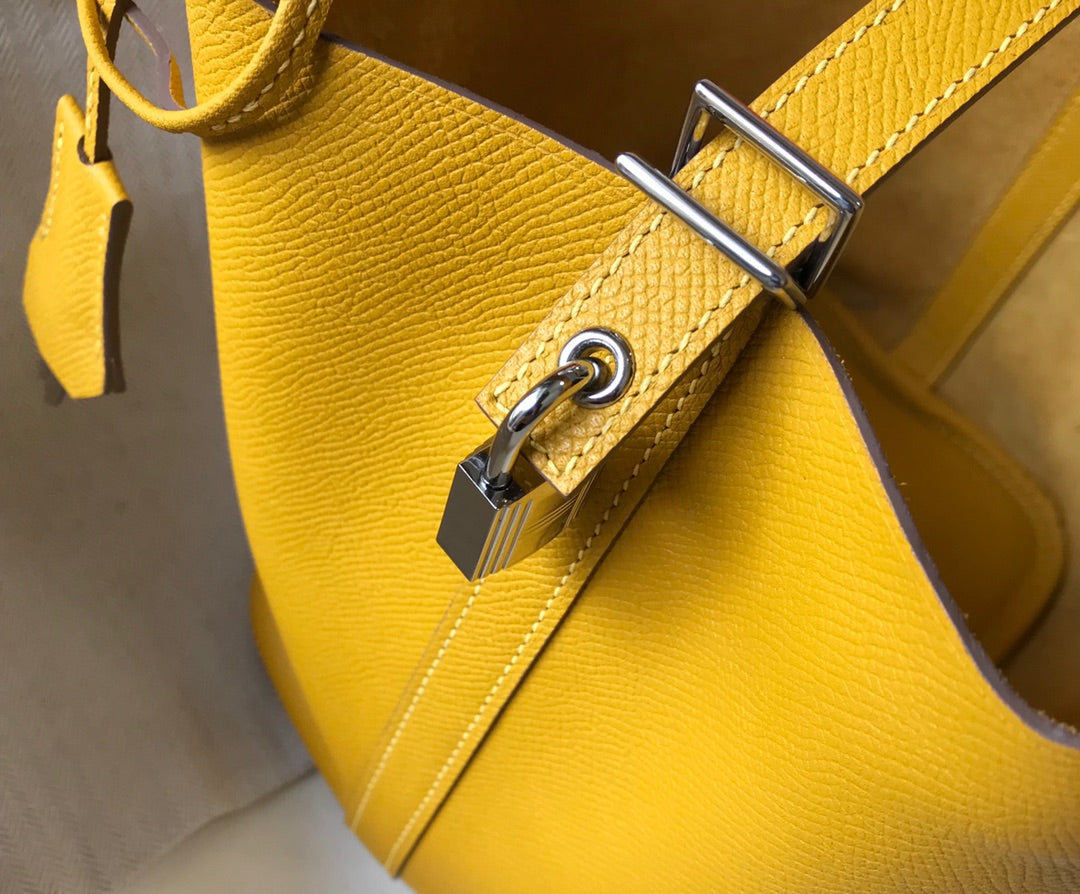 HM PICOTIN LOCK 18 YELLOW CALFSKIN WITH BRAID STRAP