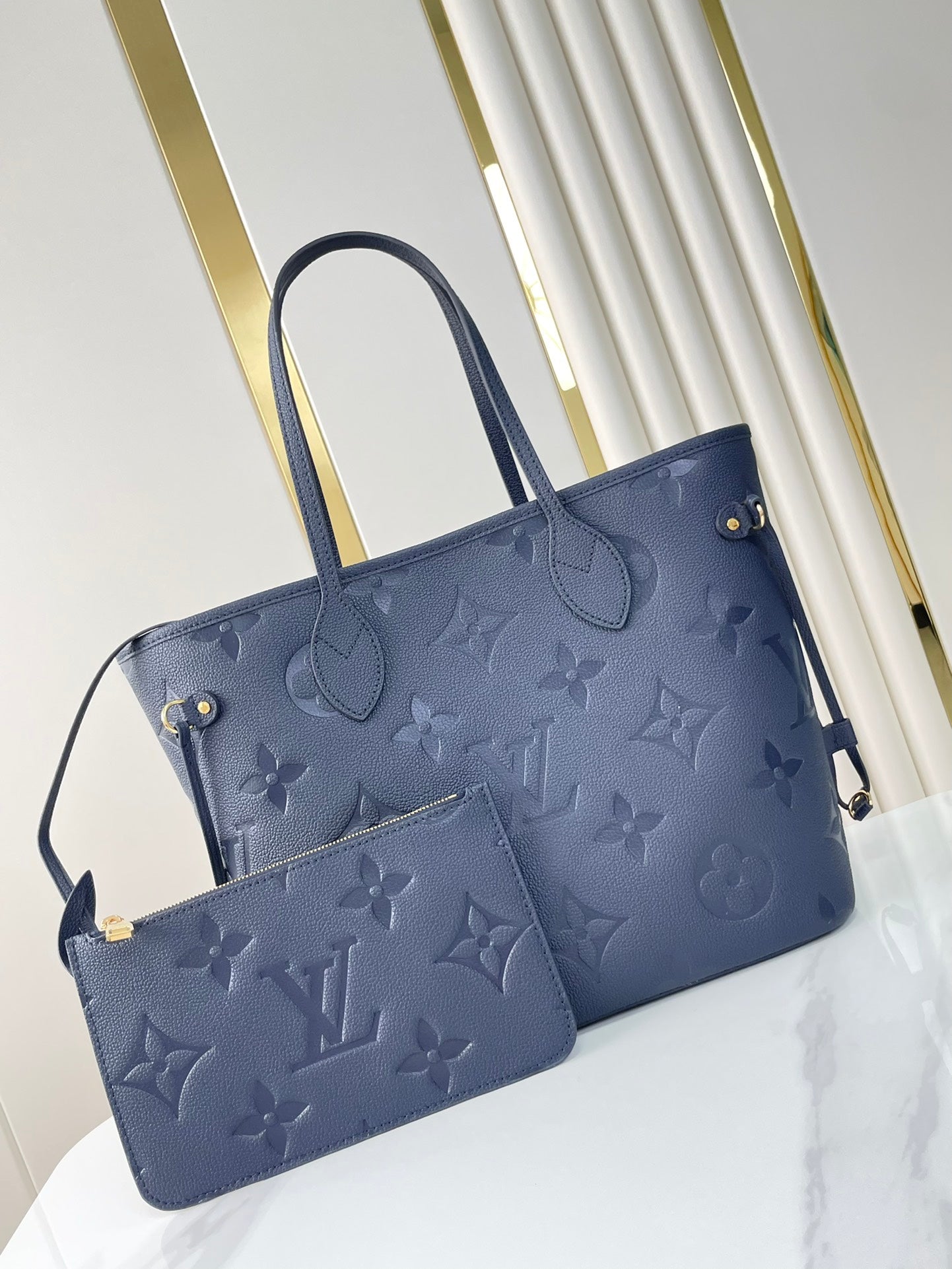 NEVERFULL MM 31 IN DARK NAVY MONOGRAM EMPREINTE LEATHER