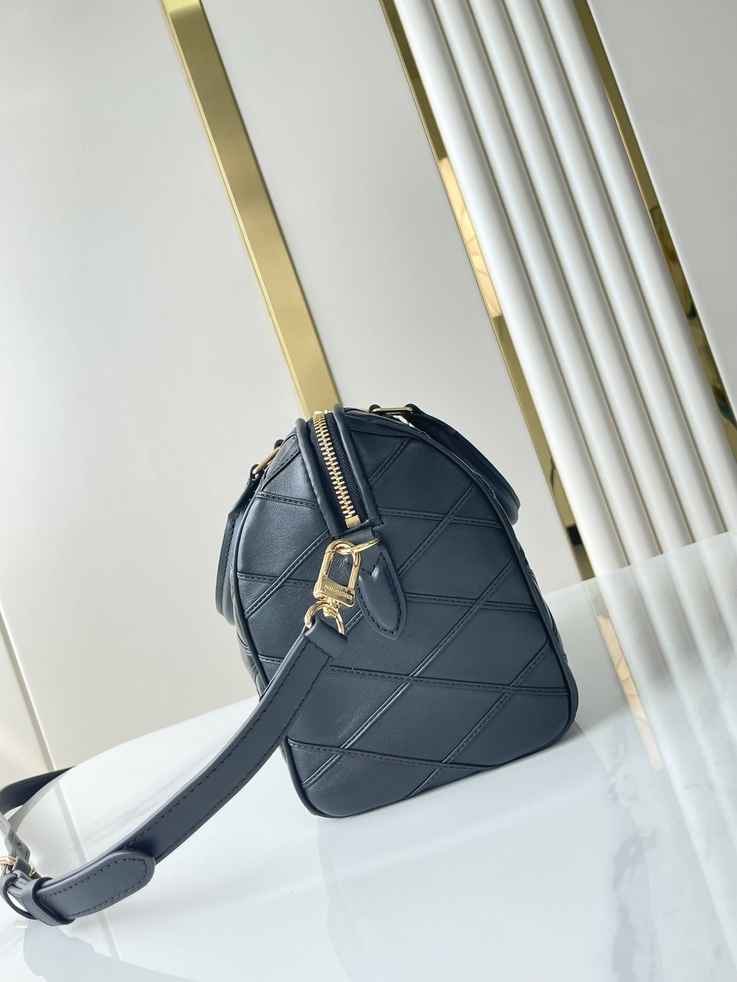 SPEEDY BANDOULIÈRE 25 WITH CRISS CROSS PATTERN IN BLACK LAMBSKIN