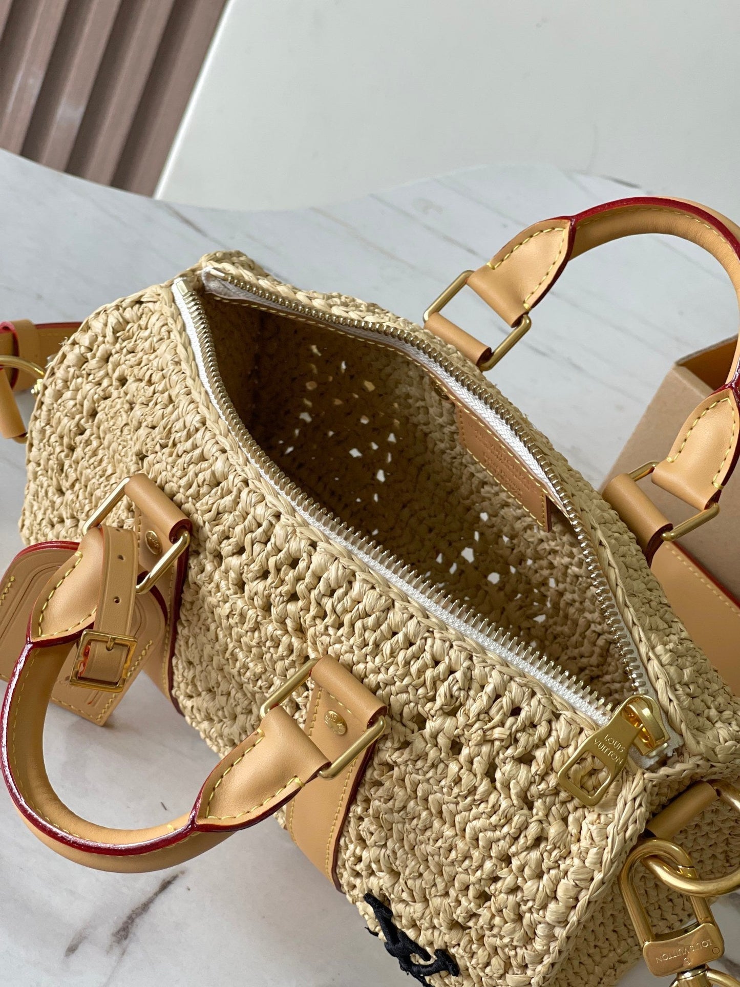 KEEPALL BANDOULIÈRE 25 IN BEIGE CROCHETED RAFFIA AND CALFSKIN TRIM