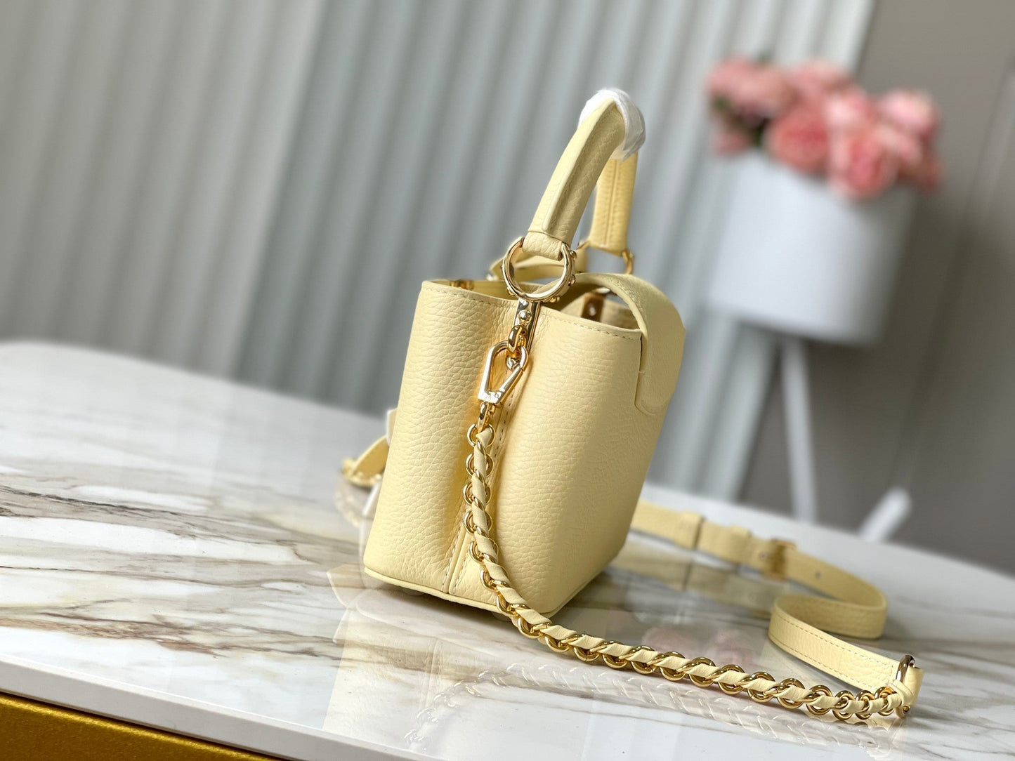 CAPUCINES EAST-WEST MINI 22 IN BANANA YELLOW TAURILLON GOLD HARDWARE