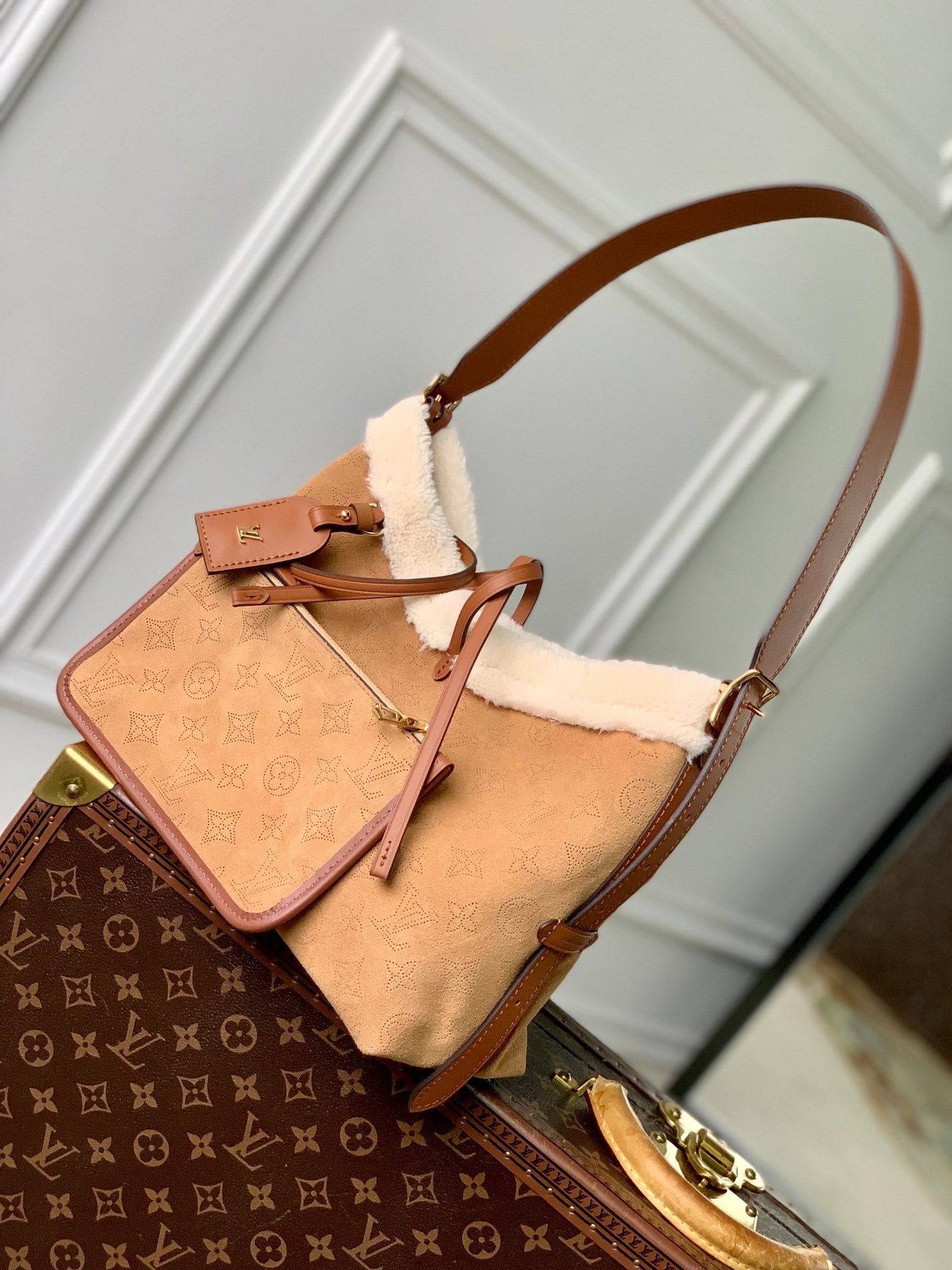 CARRYALL PM 29 IN CIDER BROWN MONOGRAM PERFORATED SUEDE AND WHITE SHEARLING TRIM