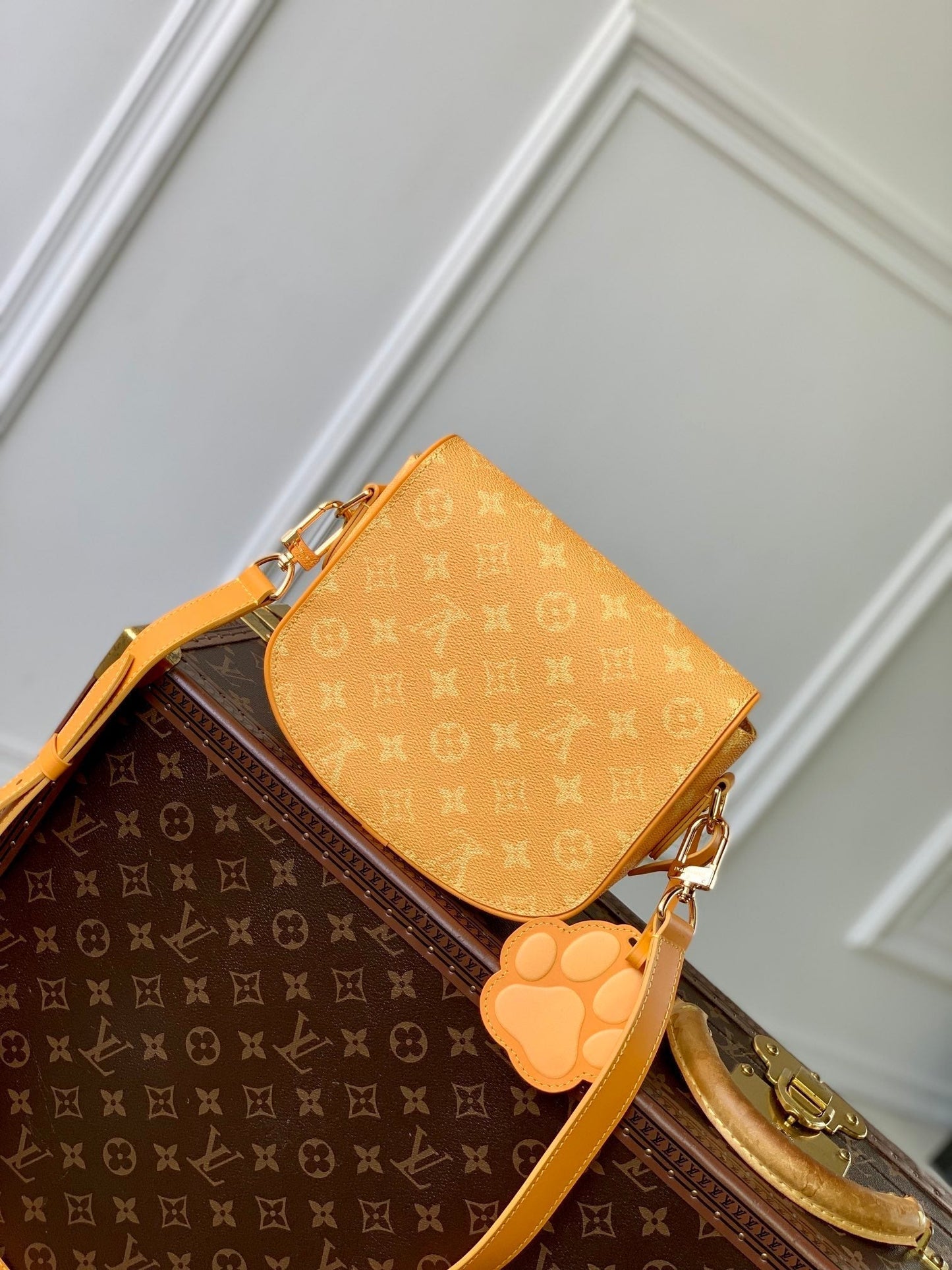 MONTSOURIS MESSENGER PM 20 IN PEPPER ORANGE MONOGRAM HERITAGE CANVAS