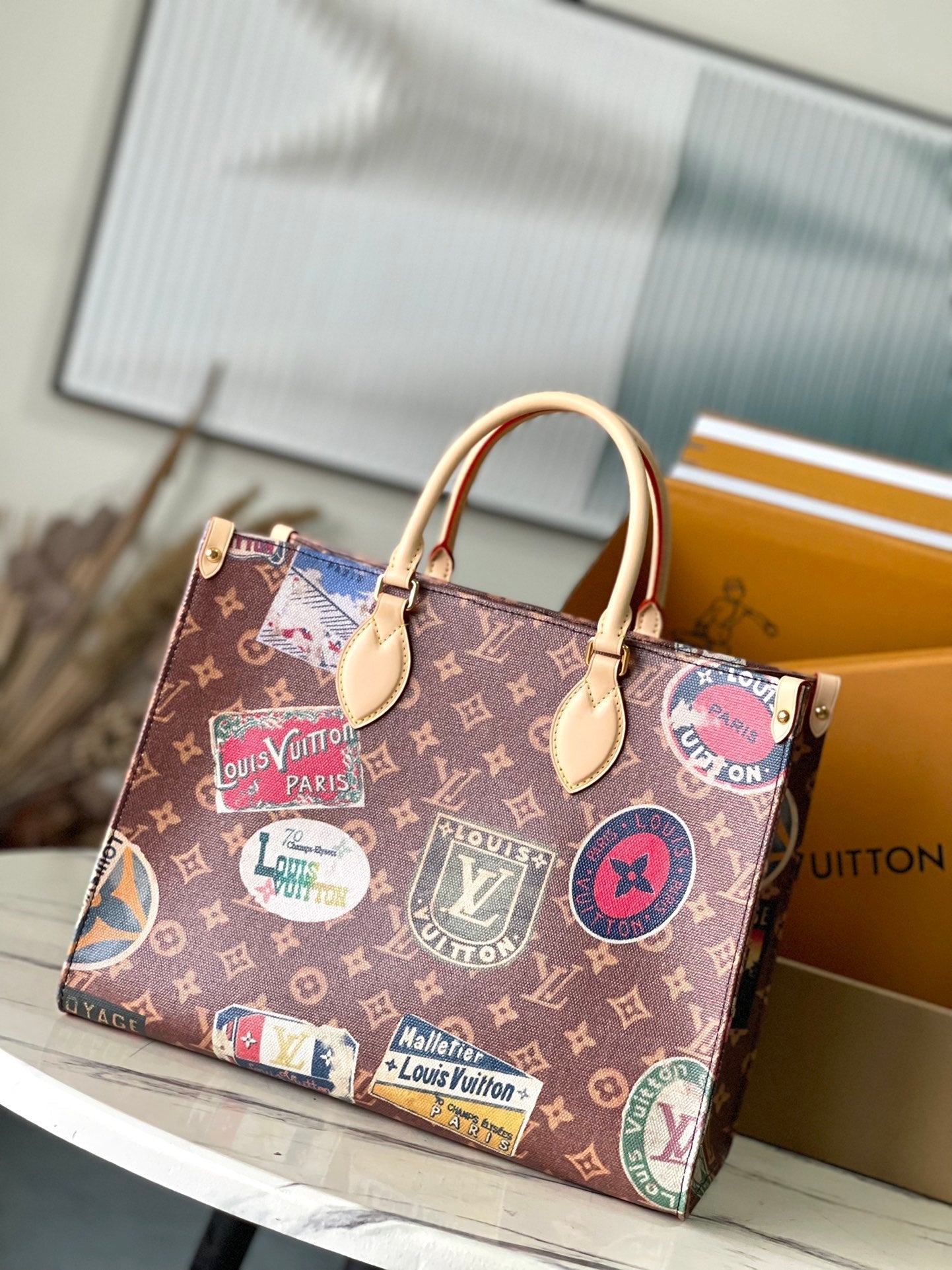 ONTHEGO VOYAGE 35 IN BROWN MONOGRAM CANVAS WITH VINTAGE HOTEL LABELS