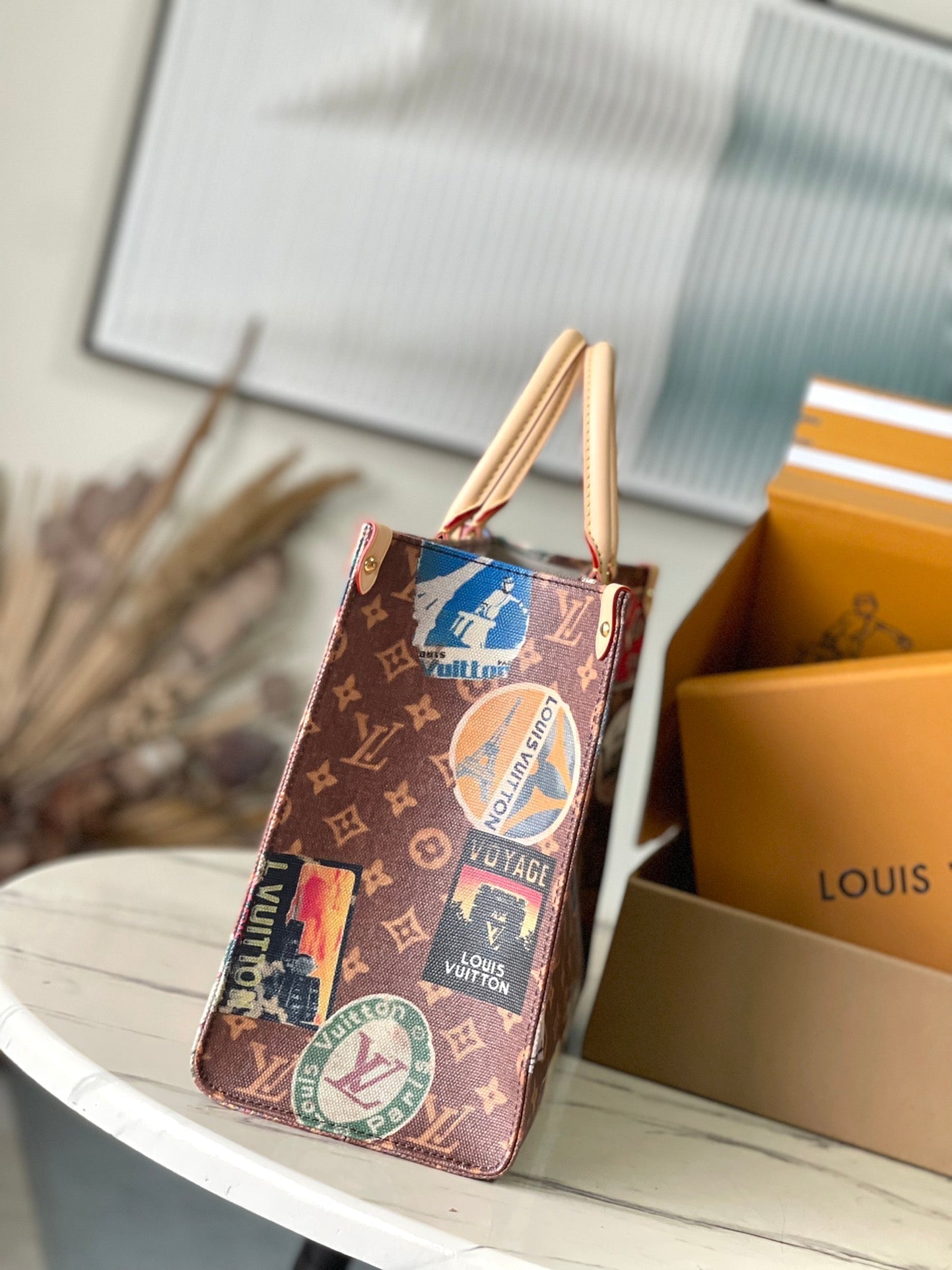 ONTHEGO VOYAGE 35 IN BROWN MONOGRAM CANVAS WITH VINTAGE HOTEL LABELS