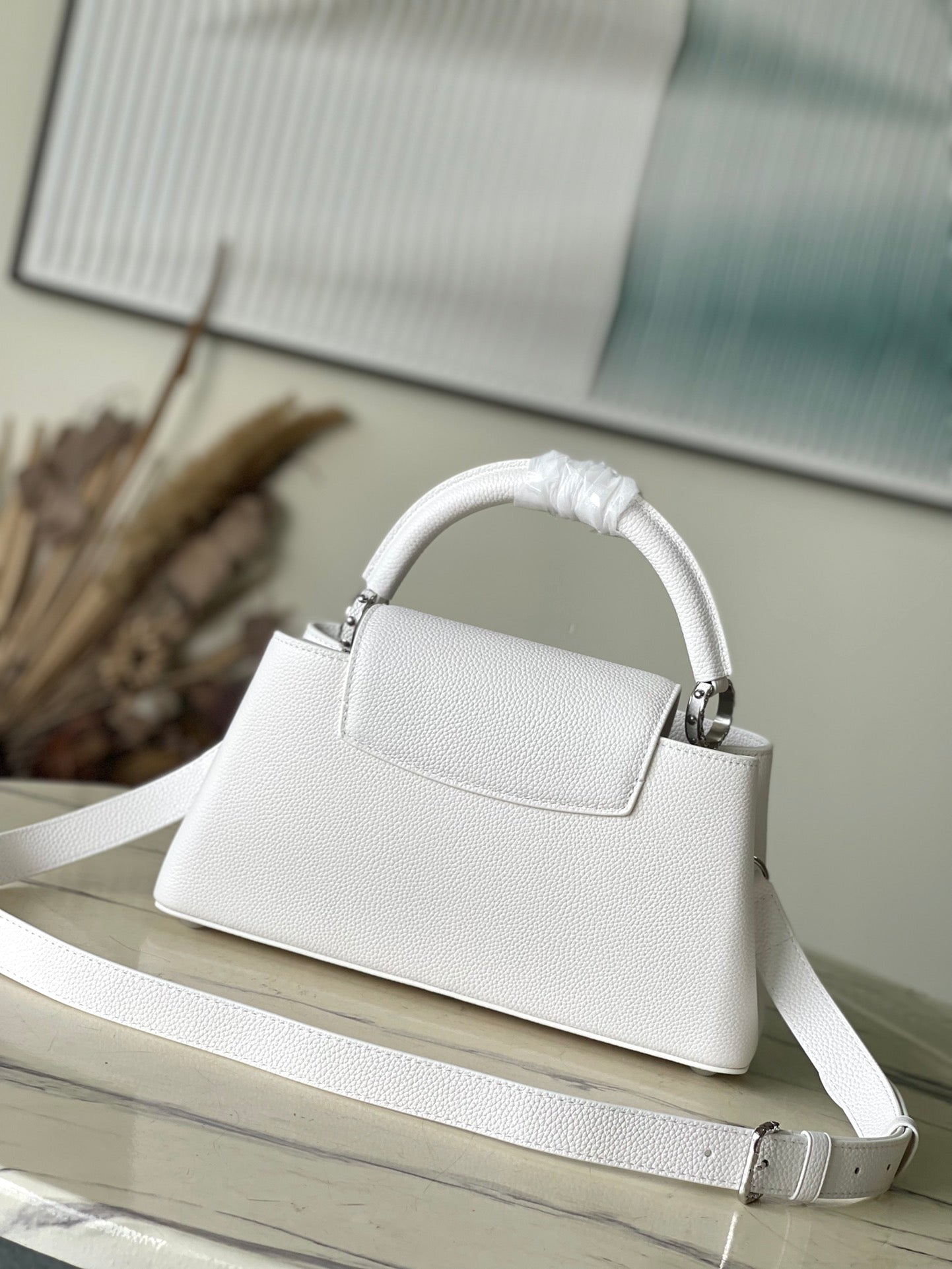 CAPUCINES EAST-WEST 33 IN WHITE CALFSKIN SILVER HARDWARE