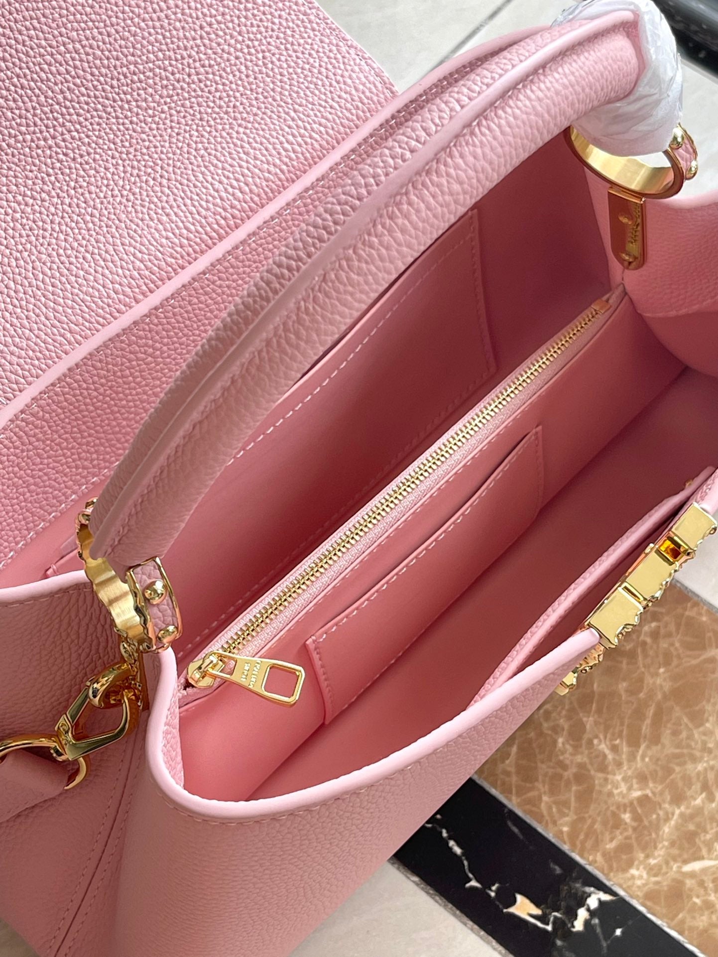 CAPUCINES EAST-WEST 33 IN BLUSH PINK CALFSKIN GOLD HARDWARE