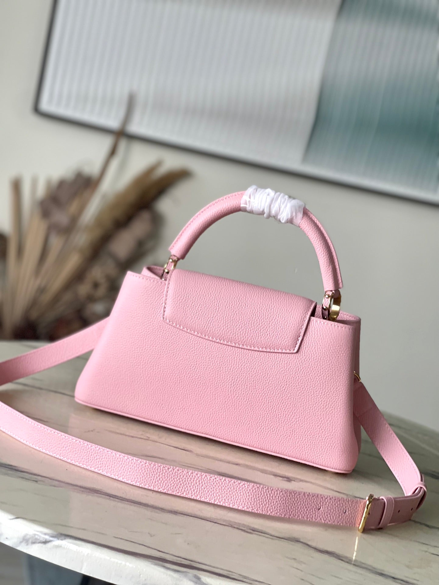 CAPUCINES EAST-WEST 33 IN BLUSH PINK CALFSKIN GOLD HARDWARE