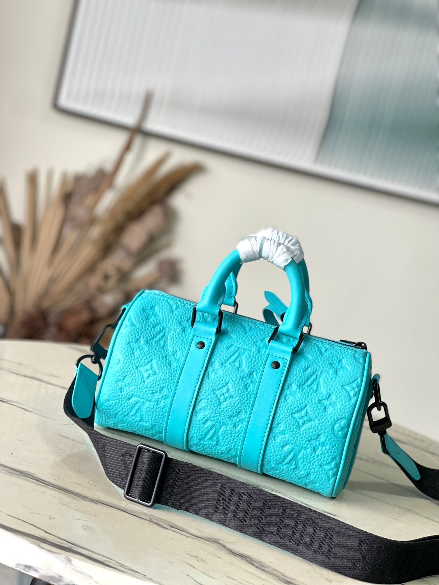 KEEPALL BANDOULIÈRE 25 IN TURQUOISE BLUE MONOGRAM EMBOSSED CALFSKIN