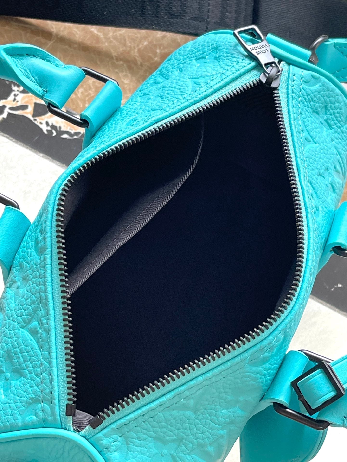 KEEPALL BANDOULIÈRE 25 IN TURQUOISE BLUE MONOGRAM EMBOSSED CALFSKIN