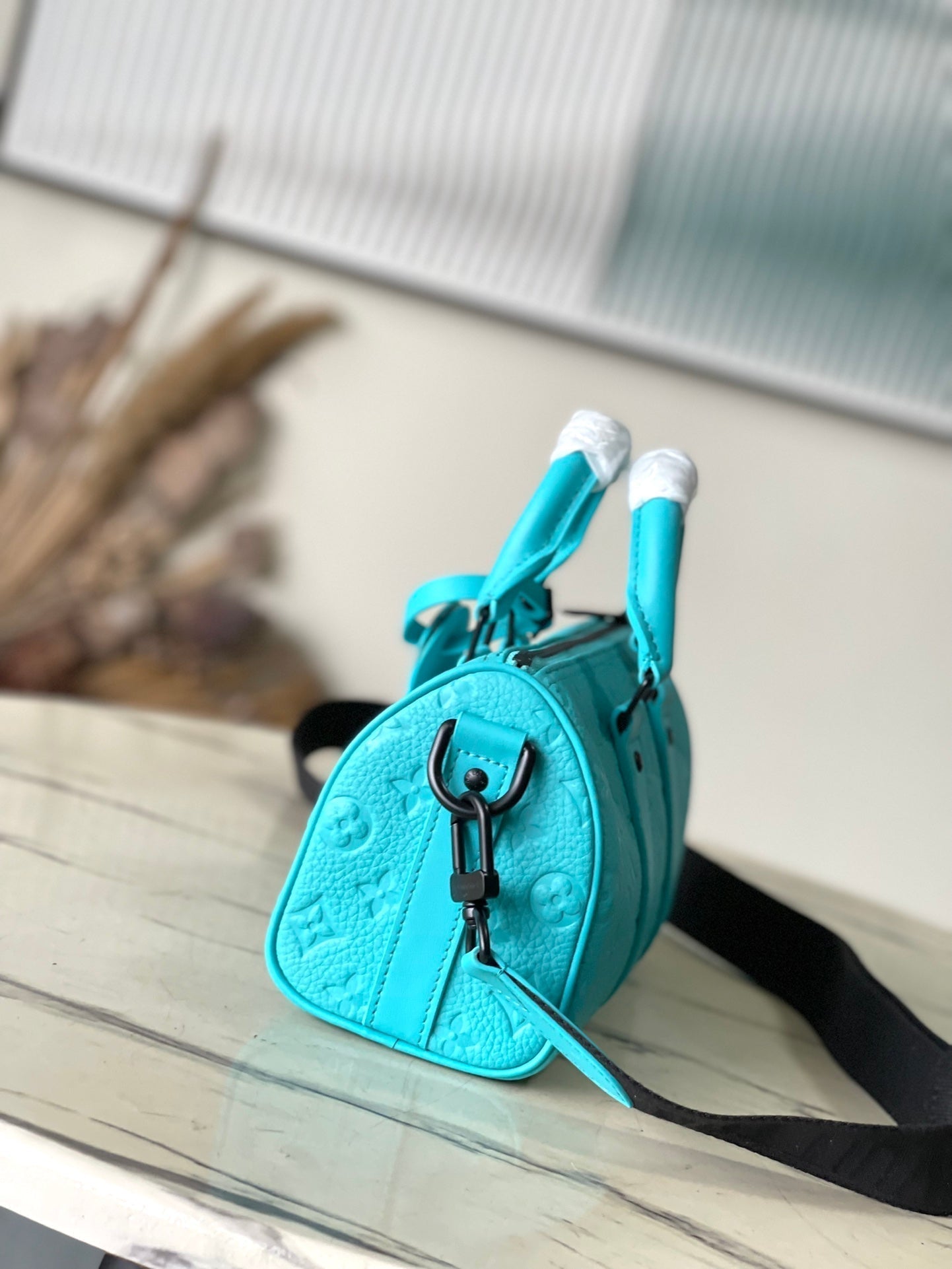 KEEPALL BANDOULIÈRE 25 IN TURQUOISE BLUE MONOGRAM EMBOSSED CALFSKIN