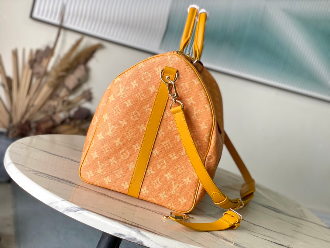 KEEPALL BANDOULIÈRE 55 IN ORANGE MONOGRAM HERITAGE CANVAS