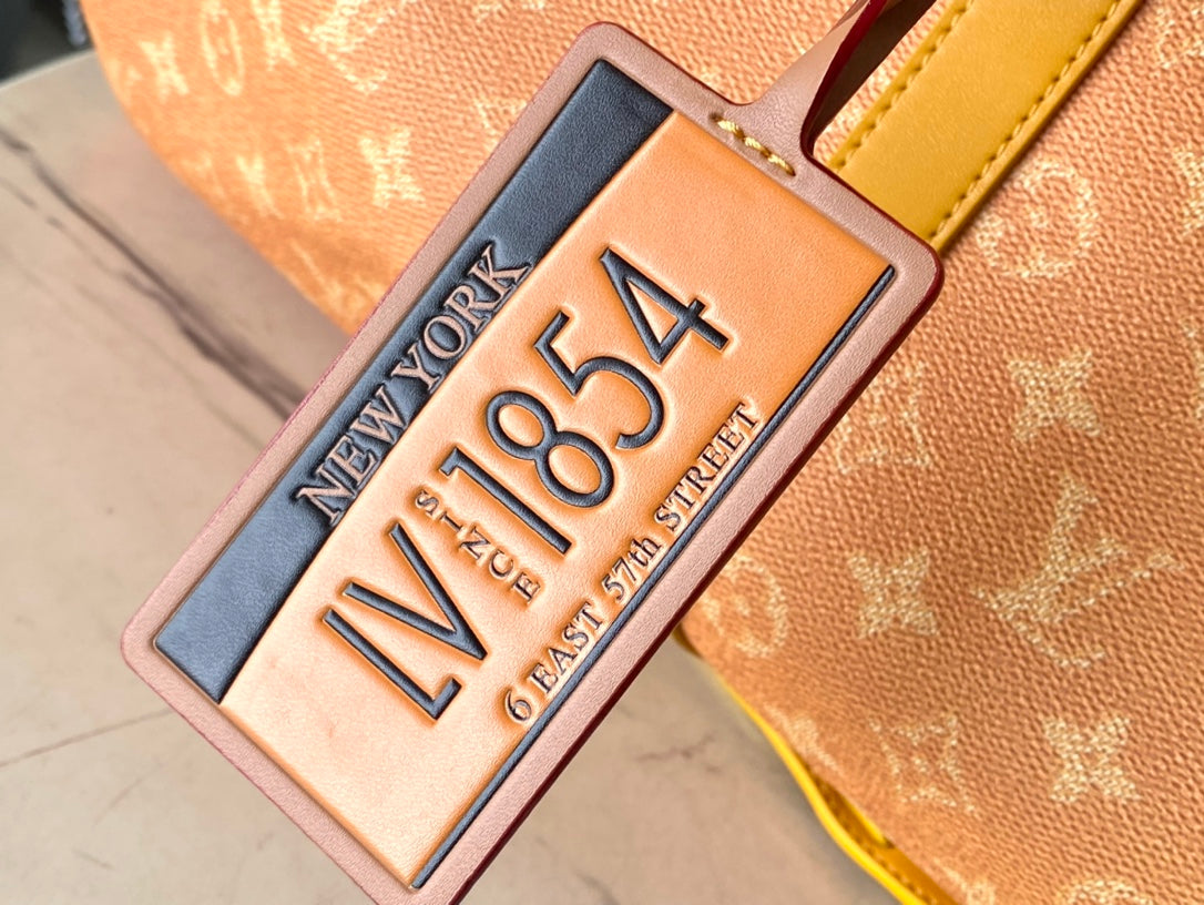 KEEPALL BANDOULIÈRE 55 IN ORANGE MONOGRAM HERITAGE CANVAS