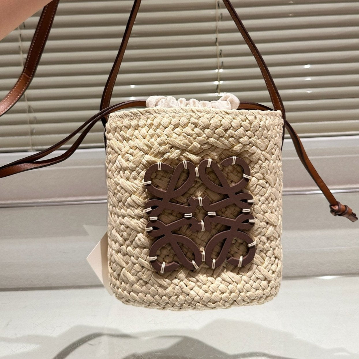 LOE ANAGRAM MINI 18 BUCKET BAG IN NATURAL RAFFIA