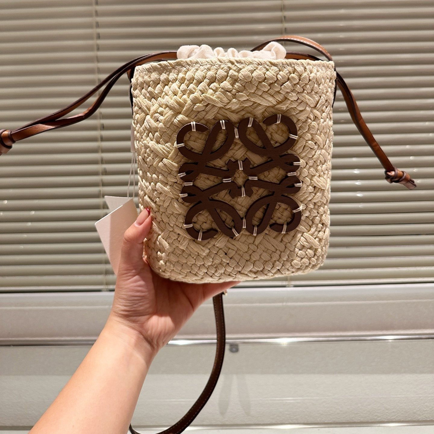 LOE ANAGRAM MINI 18 BUCKET BAG IN NATURAL RAFFIA