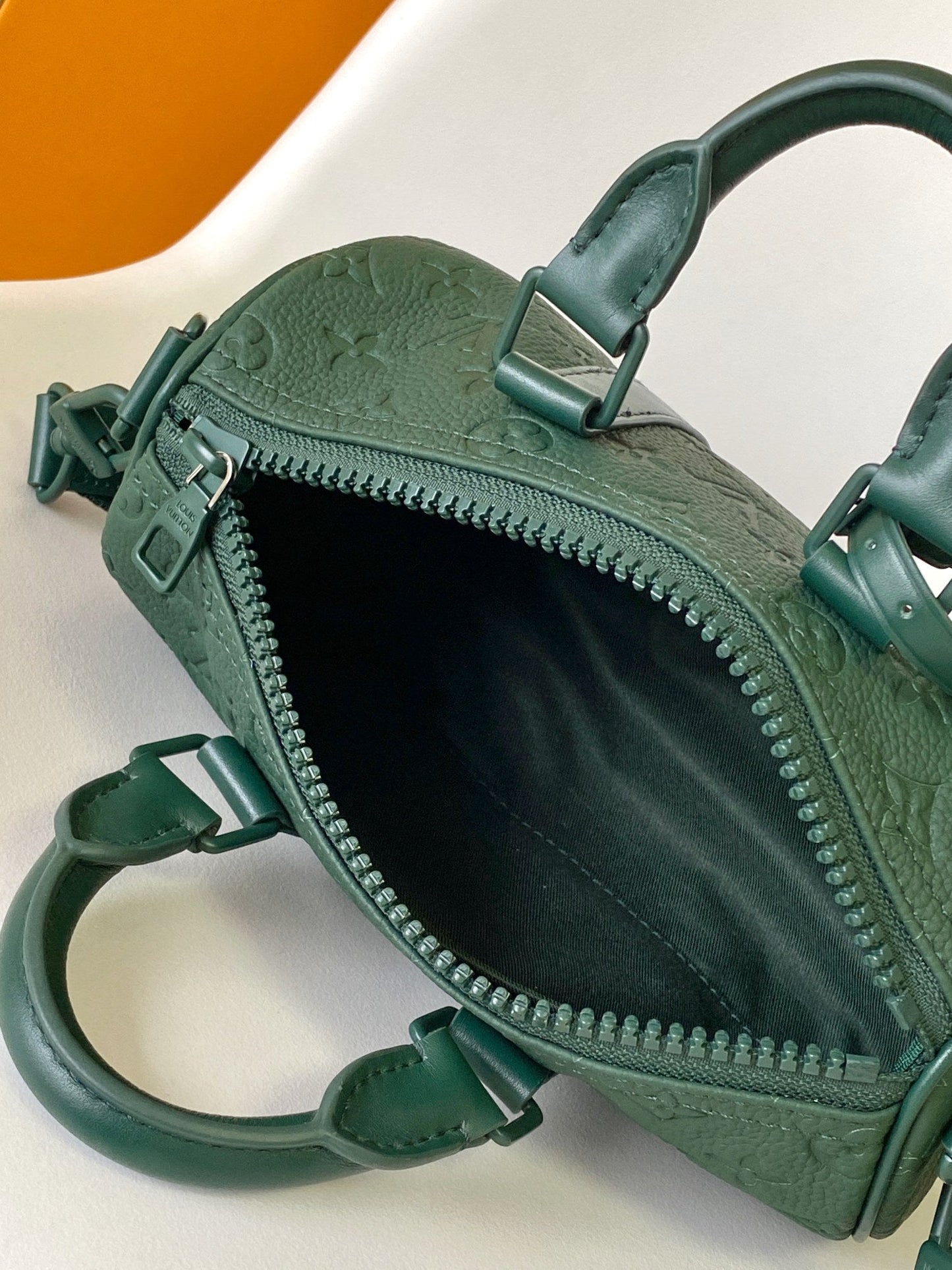 KEEPALL BANDOULIÈRE 25 IN FOREST GREEN MONOGRAM EMBOSSED CALFSKIN